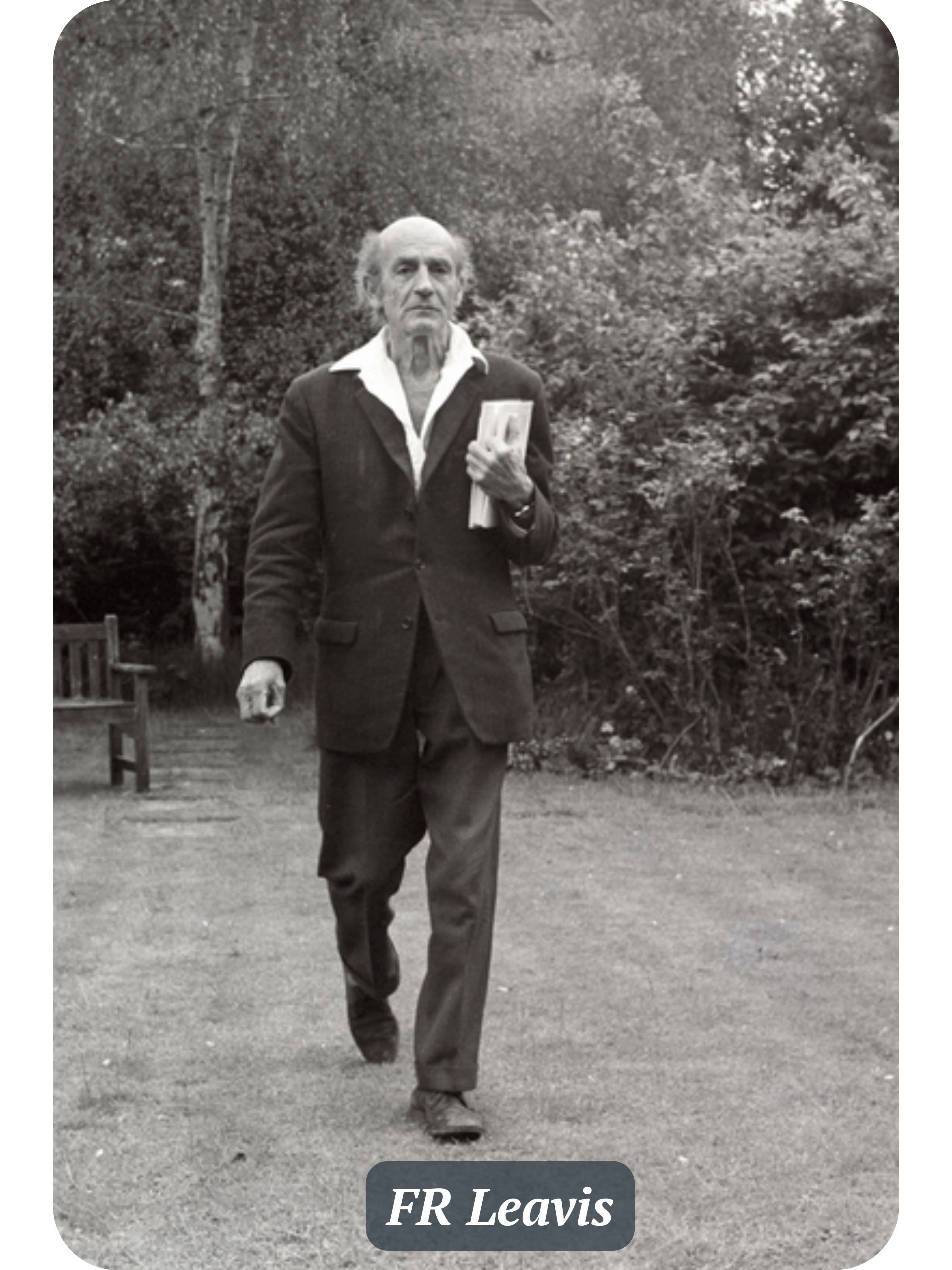 FR Leavis is walking and holding a book